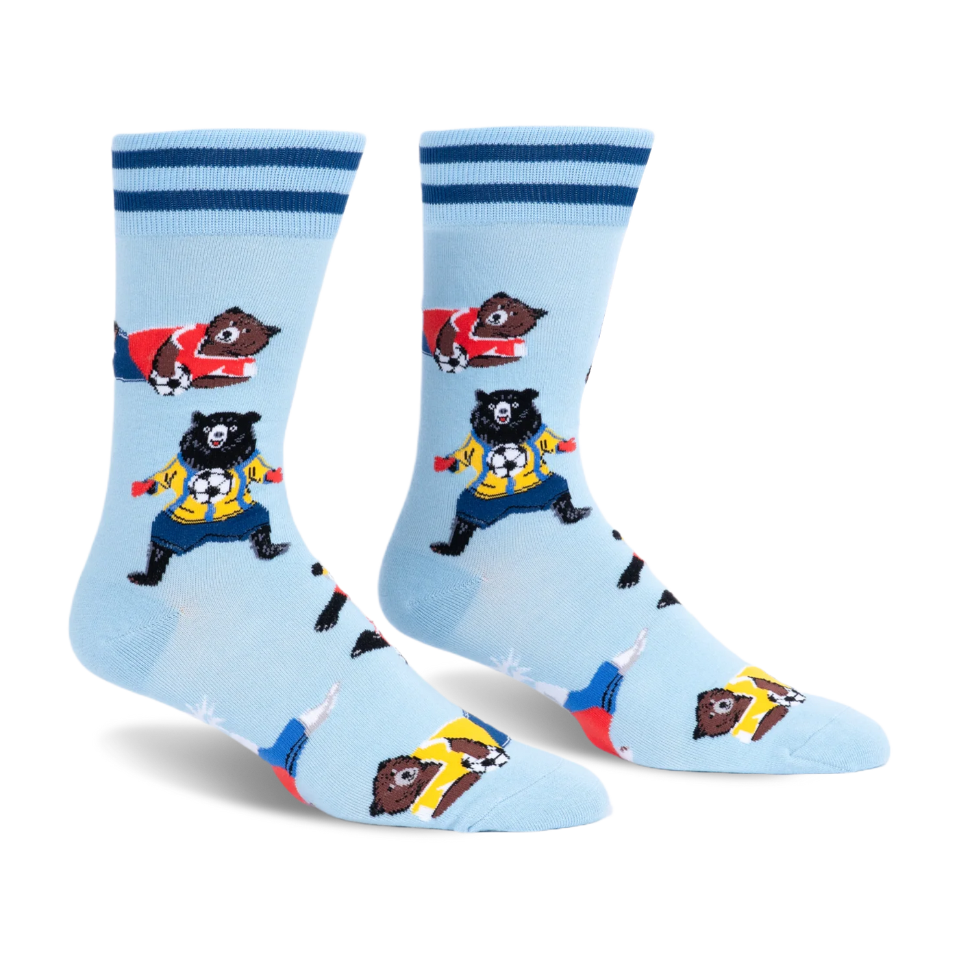 Light blue crew socks with dark blue cuff stripes featuring brown and black bears in colorful jerseys playing soccer.