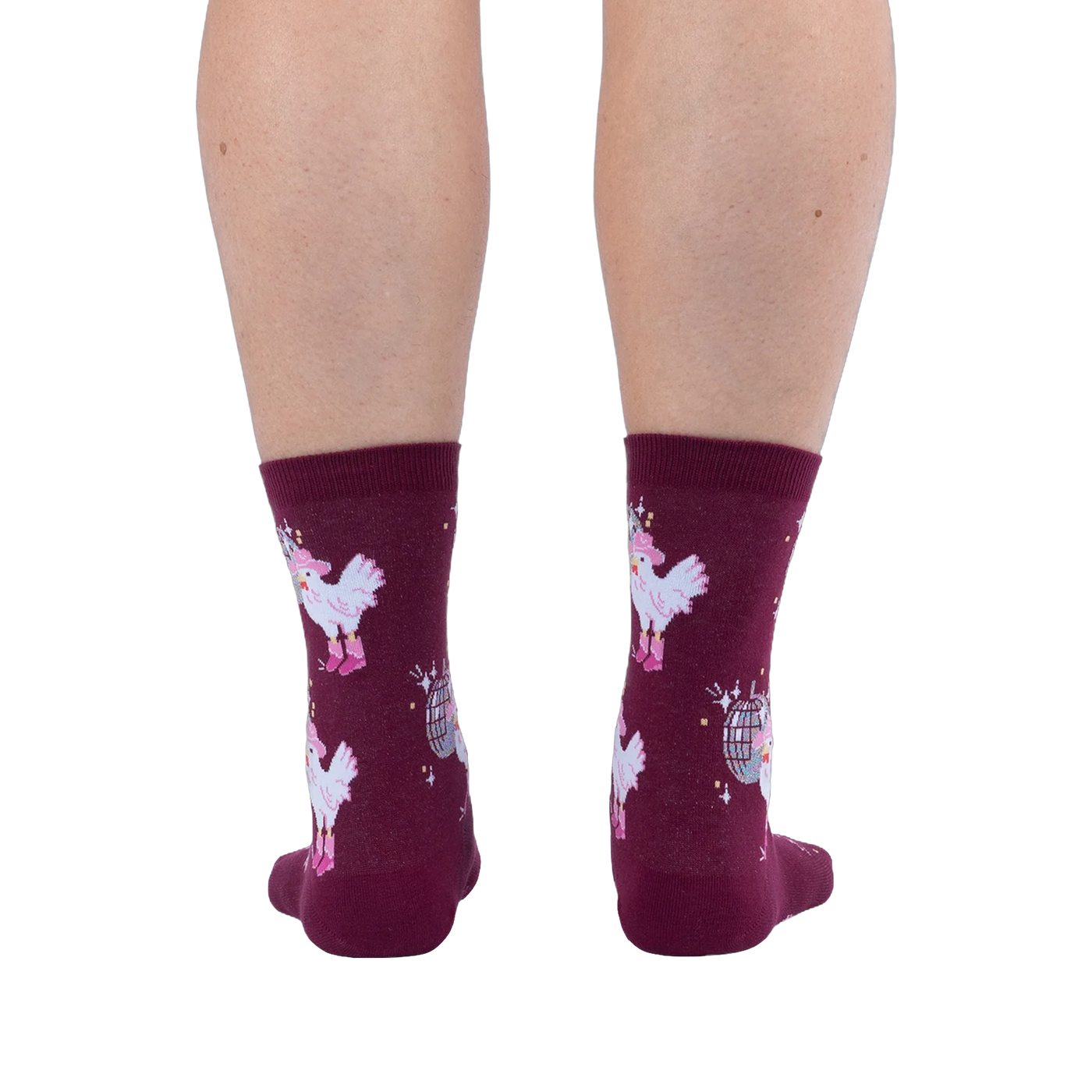 Back view of legs wearing burgundy crew socks featuring white chickens in pink boots and disco balls on a black background.