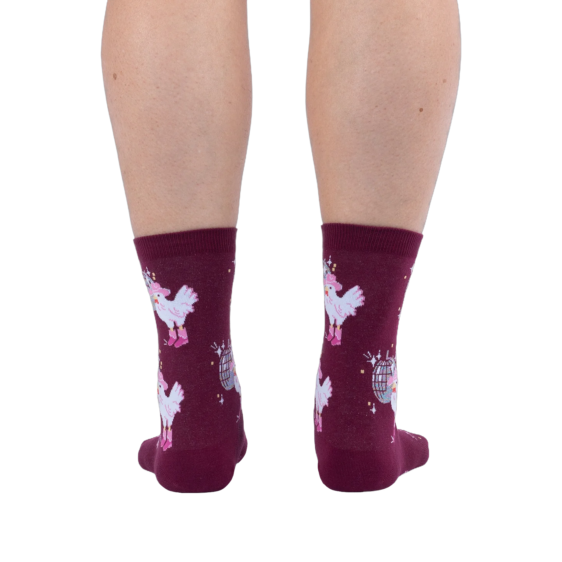 Back view of legs wearing burgundy crew socks featuring white chickens in pink boots and disco balls on a black background.