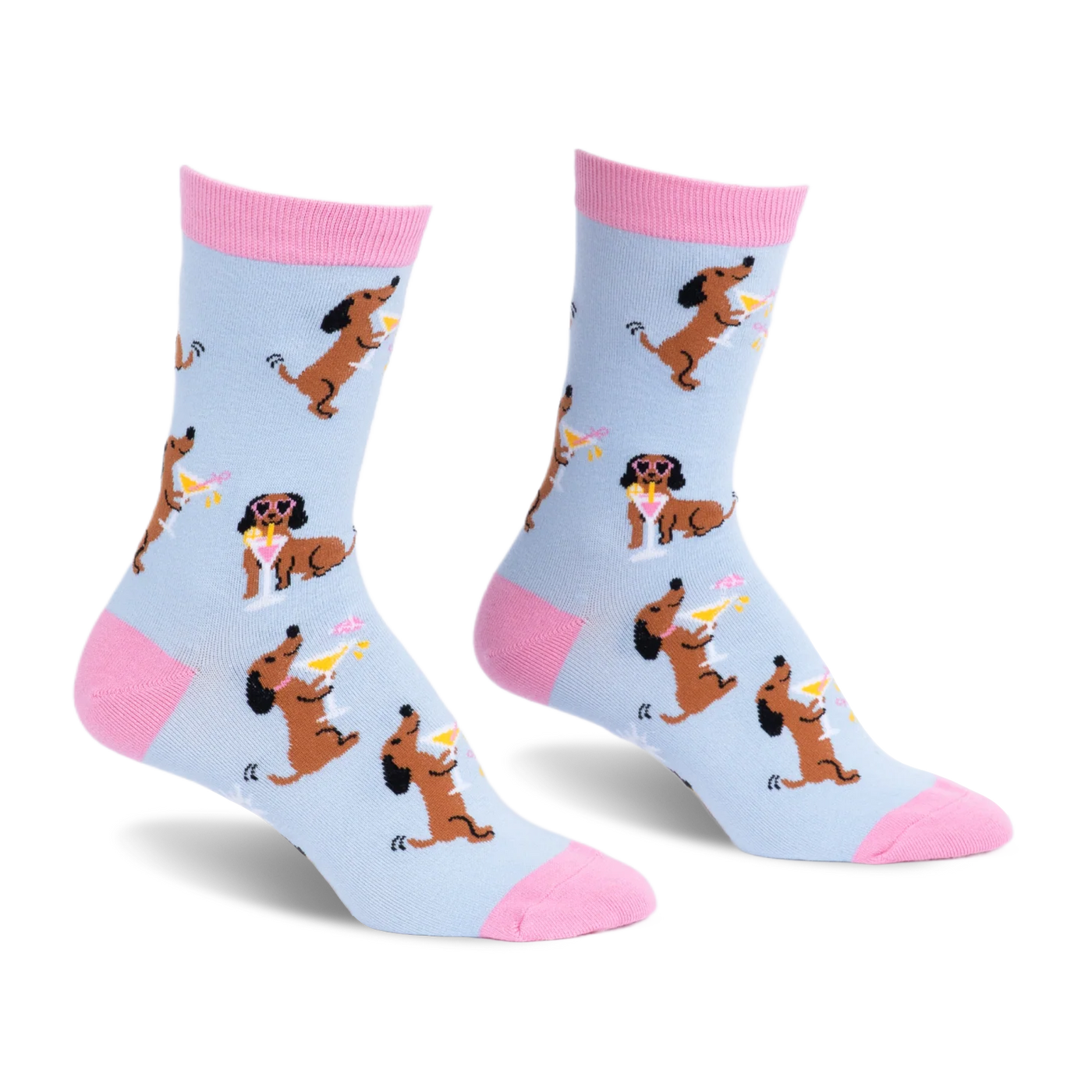 Light blue crew socks with pink accents, featuring a pattern of brown dachshunds holding martinis and wearing sunglasses.