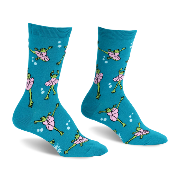 Teal crew socks featuring a pattern of green frogs wearing pink tutus and dancing in ballet poses surrounded by white dots.
