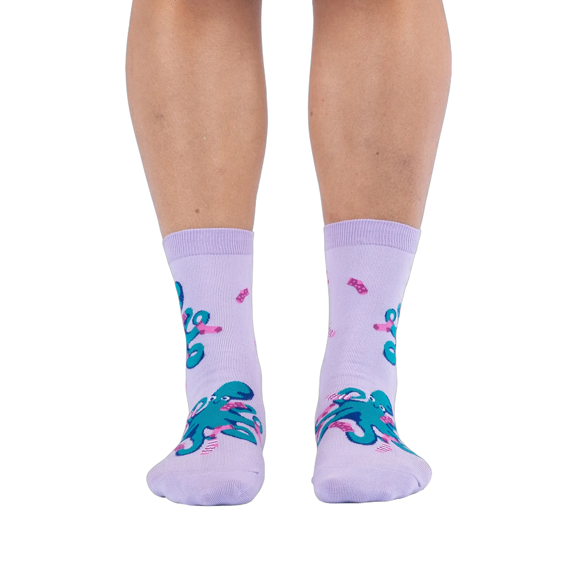 Front view of a person wearing light purple socks showing a pattern of teal octopuses wearing tiny pink socks.