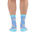 Front view of a person wearing light blue socks showing a pattern of orange goldfish in plastic bags and bright aqua cuffs.