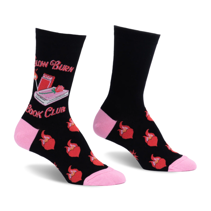 Black crew socks with pink heel and toe. Features Slow Burn Book Club text, a pink book, lit match, and flaming red hearts.