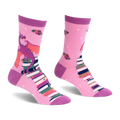 Pink crew socks featuring a purple dragon with orange wings sitting on a tall stack of books with scattered red roses.
