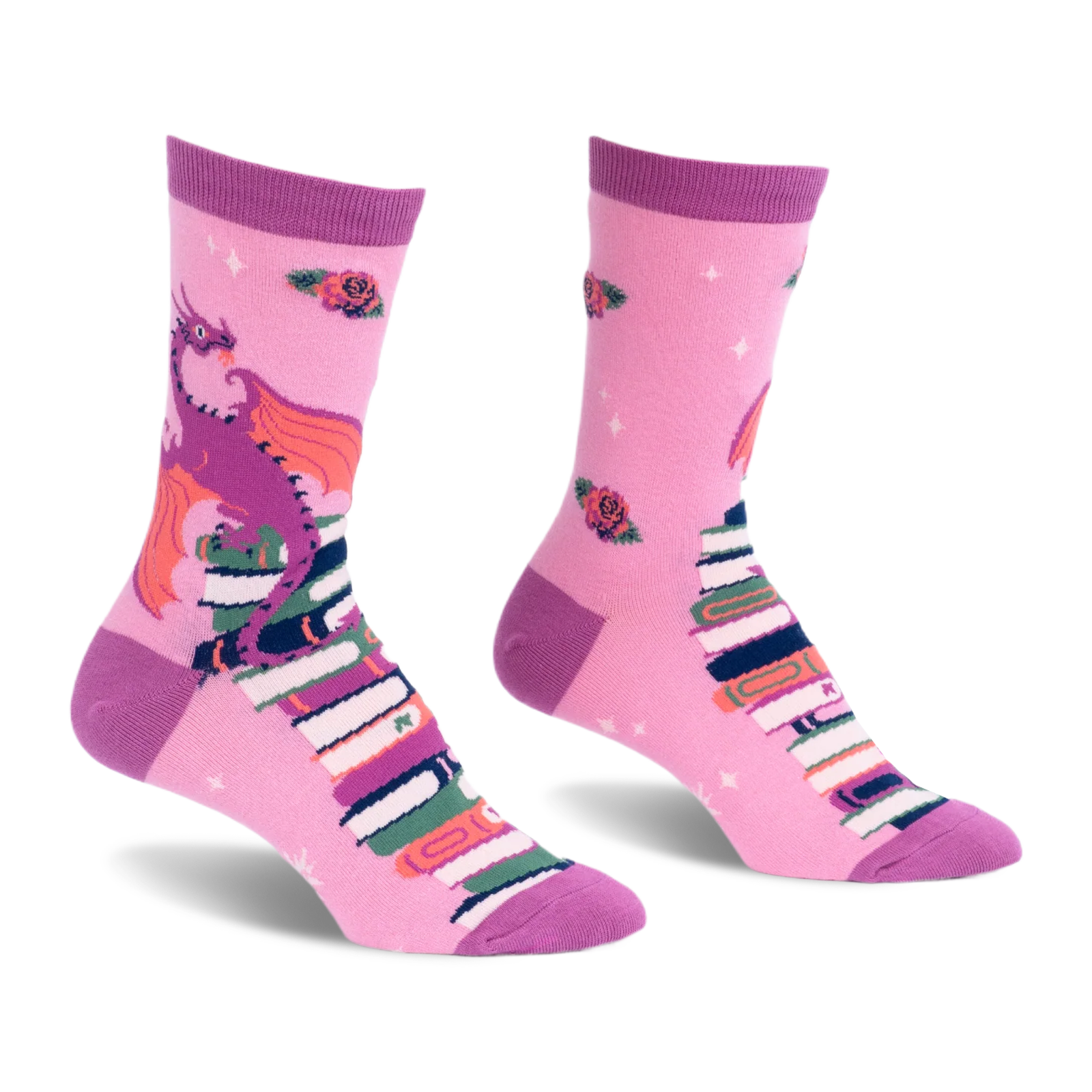 Pink crew socks featuring a purple dragon with orange wings sitting on a tall stack of books with scattered red roses.