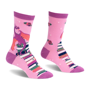 Pink crew socks featuring a purple dragon with orange wings sitting on a tall stack of books with scattered red roses.
