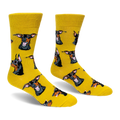 A pair of bright yellow crew socks featuring a pattern of black and tan Doberman dog heads, some wearing pink sunglasses.
