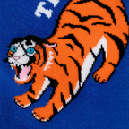 Close-up of knitted orange tiger graphic on a blue sock showing black stripes, blue eyes, white details, and a pink tongue.