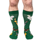 Front view of someone wearing the green socks, showing white, speckled, brown, and crested chickens with orange eggs.