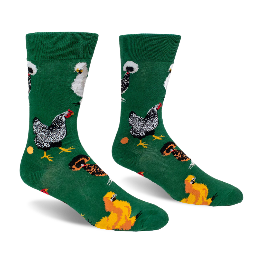 Green crew socks displaying a pattern of different chicken breeds, including speckled and crested, along with orange eggs.