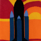 Macro shot of knitted sock fabric detailing the blue and black space shuttle silhouette against a warm striped background.