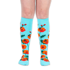 Front view of legs wearing bright turquoise knee-high socks patterned with bold red poppies and flying bumblebees.