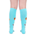 Back view of legs wearing turquoise knee-high socks, showing solid blue fabric with floral designs along the sides.