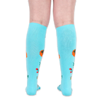 Back view of legs wearing turquoise knee-high socks, showing solid blue fabric with floral designs along the sides.