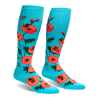 Bright turquoise knee-high socks featuring a pattern of large orange-red poppy flowers and flying yellow bumblebees.
