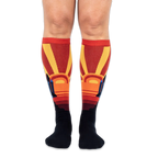 Front view of someone wearing knee-high socks, showing large yellow sunbursts and space shuttles on the outer calves.