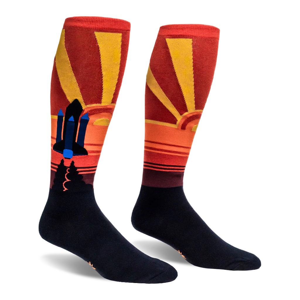 Knee-high socks showing a black and blue space shuttle set against a retro red and yellow sunburst background.