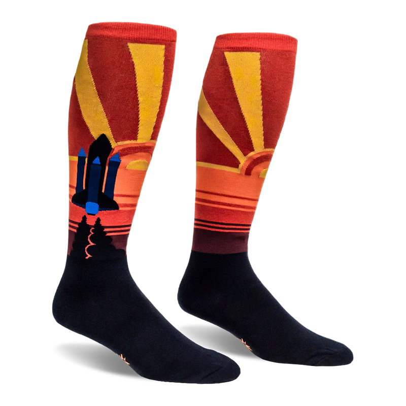 Knee-high socks showing a black and blue space shuttle set against a retro red and yellow sunburst background.