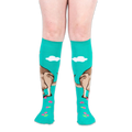 Front view of worn teal knee-high socks showing the kangaroo design wrapping around the calf and pink flowers on the feet.