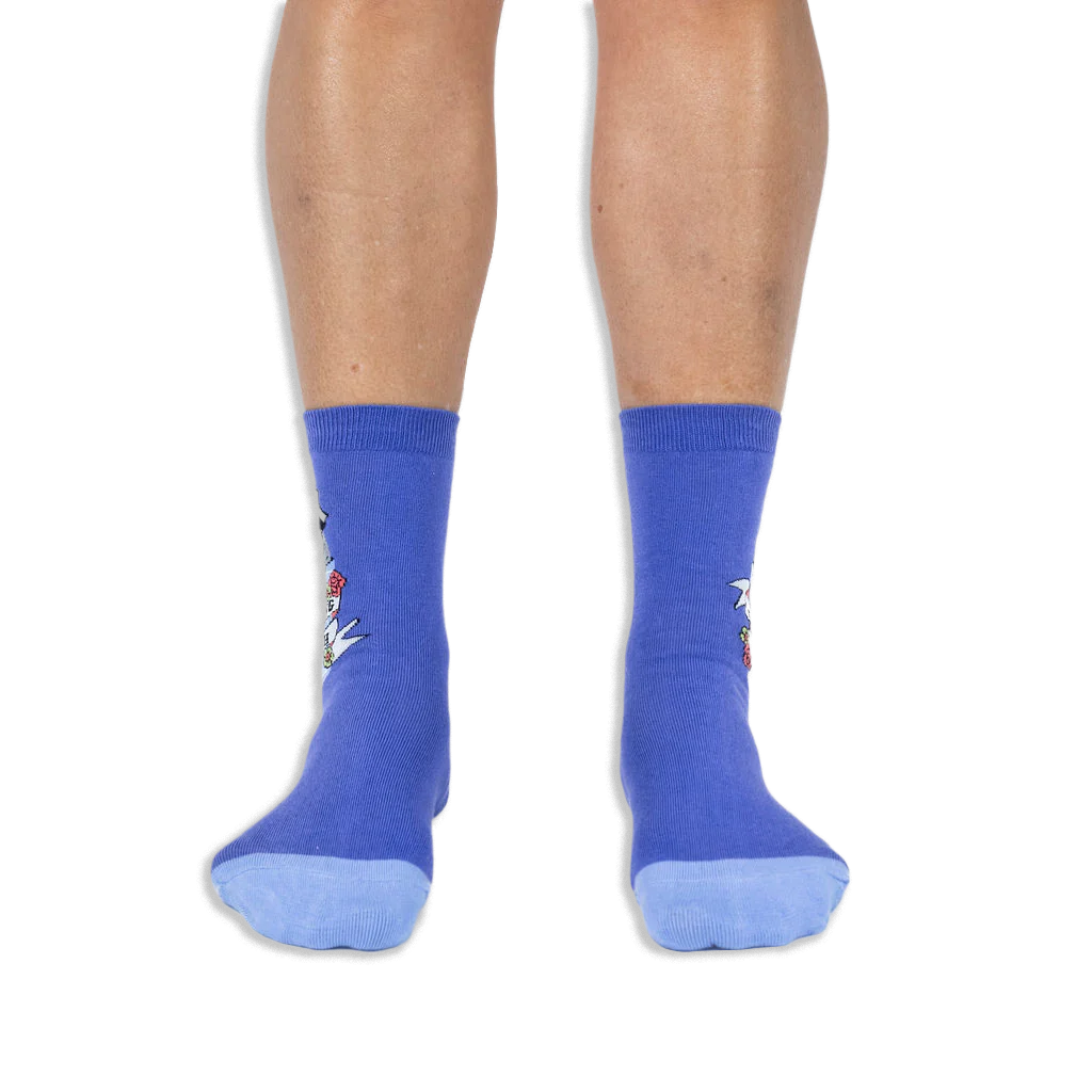 Front view of a person wearing purple crew socks with light blue toes, showing the side design wrapping around the outer edges.