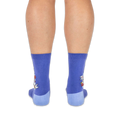 Back view of a person wearing purple crew socks with light blue heels, showing the raccoon design on the outer side edges.