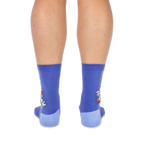 Back view of a person wearing purple crew socks with light blue heels, showing the raccoon design on the outer side edges.