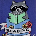 Close-up of the knit design showing a raccoon holding a green book inside a blue trash can with flowers and a Reading banner.