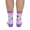 Back view of a person wearing light purple crew socks, highlighting the dark purple heel and lemon slice knit pattern.