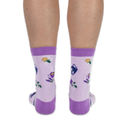 Back view of a person wearing light purple crew socks, highlighting the dark purple heel and lemon slice knit pattern.