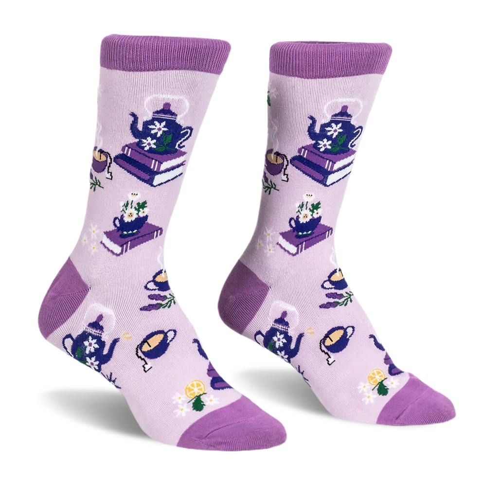 Light purple crew socks with dark purple accents featuring blue floral teapots on books, steaming cups, and lemon slices.
