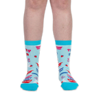 Front view of a person wearing light blue crew socks with teal trim and Thrifty B*tch text below the cuff.