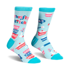 Light blue crew socks with teal trim featuring retro patterned mixing bowls, baking tools, and Thrifty B*tch text.