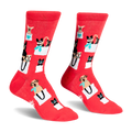 Pair of red crew socks featuring a pattern of various small dogs peeking out of white shopping bags with teal accents.