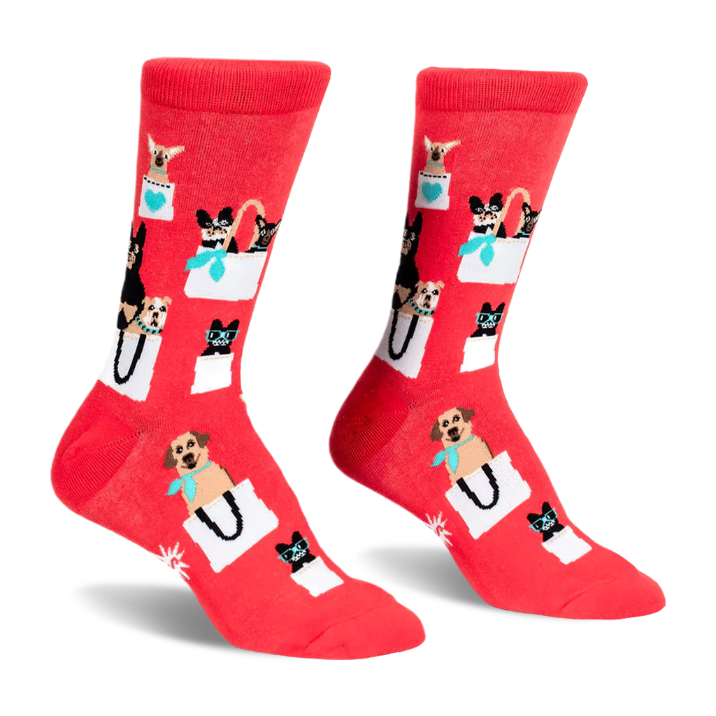 Pair of red crew socks featuring a pattern of various small dogs peeking out of white shopping bags with teal accents.