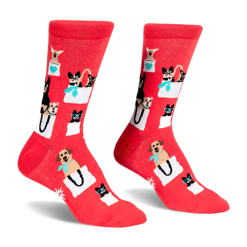 Pair of red crew socks featuring a pattern of various small dogs peeking out of white shopping bags with teal accents.