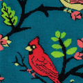Close-up knit detail of a red cardinal on a black branch with bright green leaves against a textured teal background.