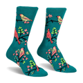 Teal crew socks featuring a pattern of red cardinals and yellow birds perched on black branches with bright pink flowers.