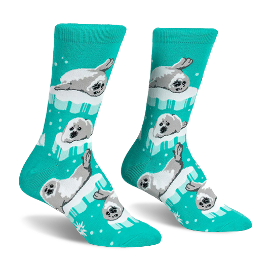 Bright teal crew socks featuring a pattern of fluffy grey and white seal pups resting on light blue and white ice floes.