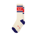 Pair of cream crew socks with red 'SLUT' text, blue-purple stripes on cuff, and blue-purple toe and heel sections.