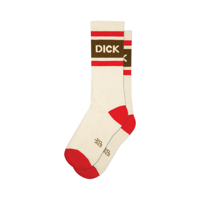 A pair of cream crew socks, one slightly behind the other. They have red striped cuffs, a brown band with "DICK" in white letters, and red heels and toes.
