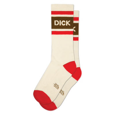 A pair of cream crew socks, one slightly behind the other. They have red striped cuffs, a brown band with "DICK" in white letters, and red heels and toes.