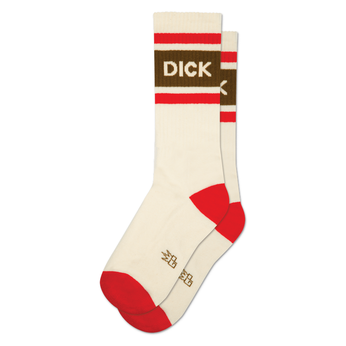 A pair of cream crew socks, one slightly behind the other. They have red striped cuffs, a brown band with 