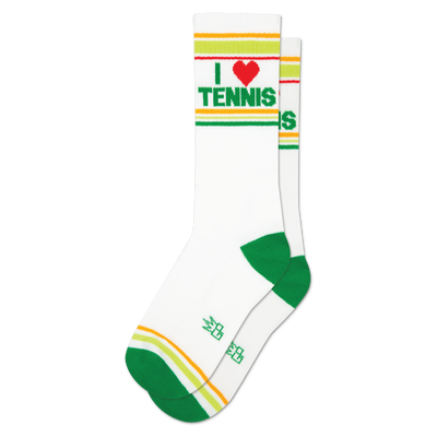 Pair of white crew socks with green and yellow-orange cuff stripes. Features 'I ❤️ TENNIS' text with a red heart. Green heels and toes.