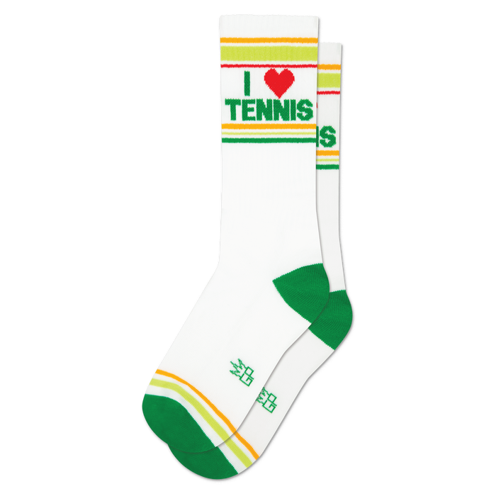 Pair of white crew socks with green and yellow-orange cuff stripes. Features 'I ❤️ TENNIS' text with a red heart. Green heels and toes.