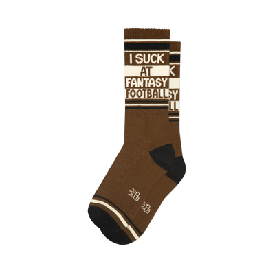A single brown crew sock with black toes and heels. Features "I SUCK AT FANTASY FOOTBALL" text on a white band.