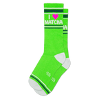 Bright green crew socks with 'I ❤️ MATCHA' text in white and a pink heart. Features white toe, heel, and striped cuffs.