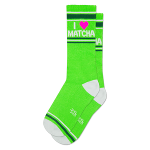 Bright green crew socks with 'I ❤️ MATCHA' text in white and a pink heart. Features white toe, heel, and striped cuffs.