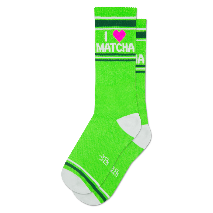 Bright green crew socks with 'I ❤️ MATCHA' text in white and a pink heart. Features white toe, heel, and striped cuffs.