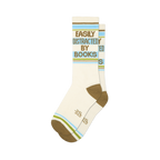 Pair of cream crew socks with 'Easily Distracted By Books' in green text, horizontal brown, blue, and green stripes.
